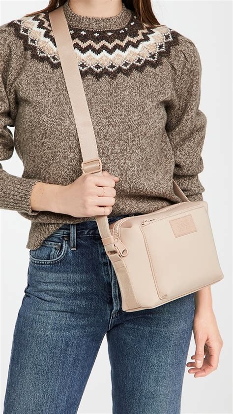 Known for its neoprene bags, Dagne Dovers Puff collection includes this diminutive Kitty bag that is ideal for traveling. . Dagne dover crossbody